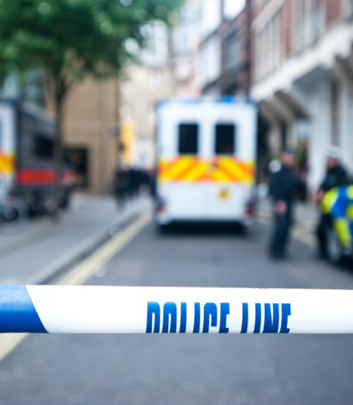 Police line tape in front of a crime scene