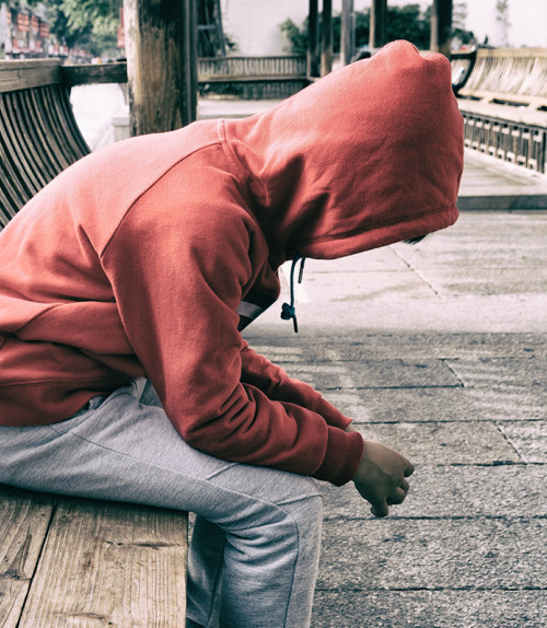 Hooded child on bench