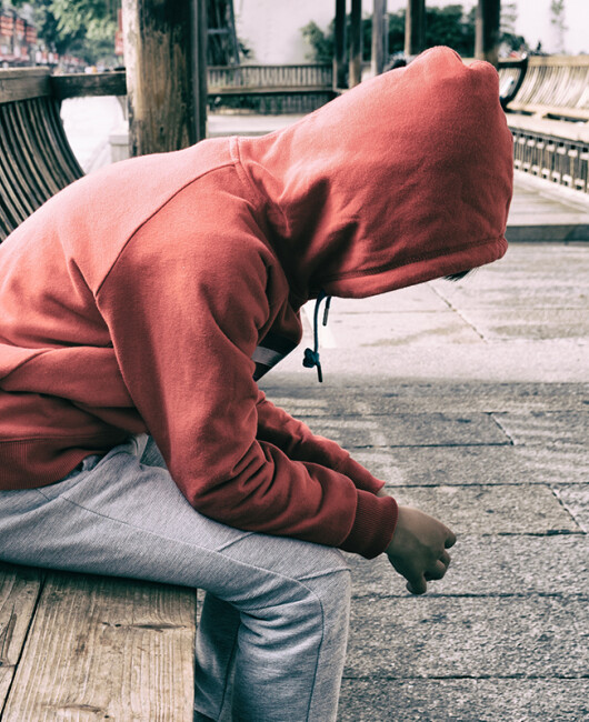 Hooded child on bench