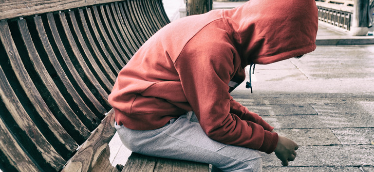 Hooded child on bench