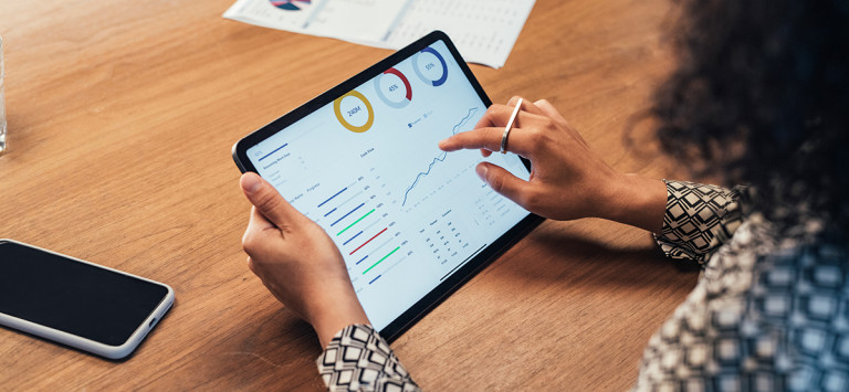 Woman using a tablet to read statistics